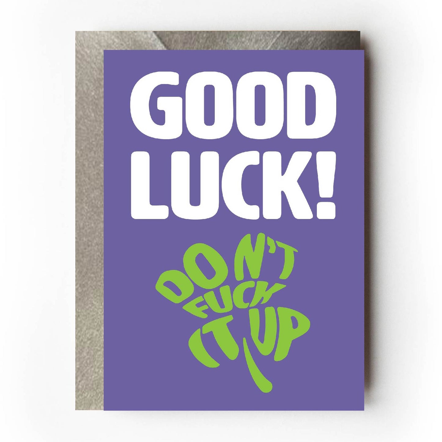 Text on card is white and green against a purple background and states "Good luck!" In the shape of a four-leaf clover, further text also states "Don't fuck it up" Card measures 105 x 150mm and is supplied with a very striking pewter-effect eco-Kraft envelope.