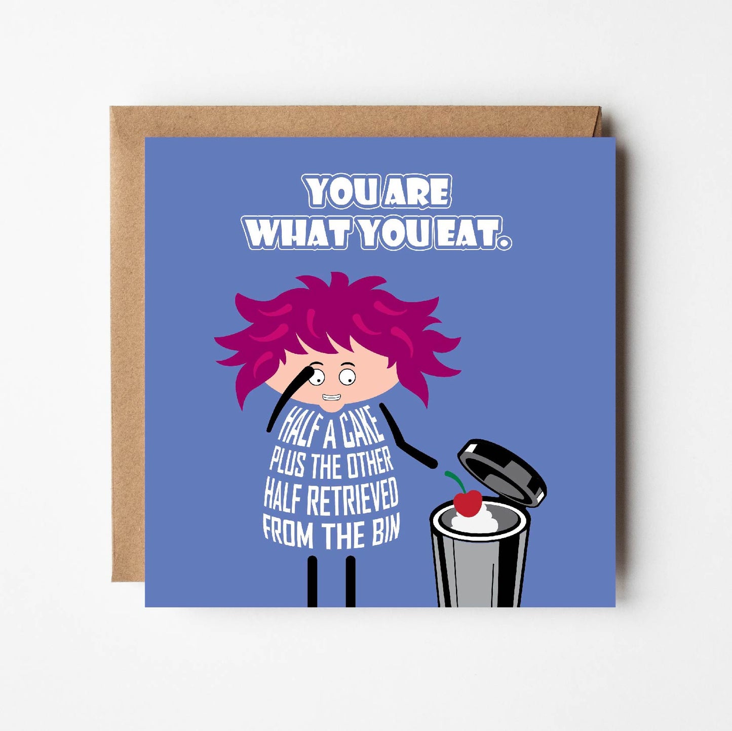 Card titled “You are what you eat” in white text on a blue background. A cartoon lady with wild pink hair looks into her trash can filled with cake. Her dress is formed from text which states “Half a cake plus the other half retrieved from the bin.” Card is 150mm square. Supplied with eco-Kraft envelope.
