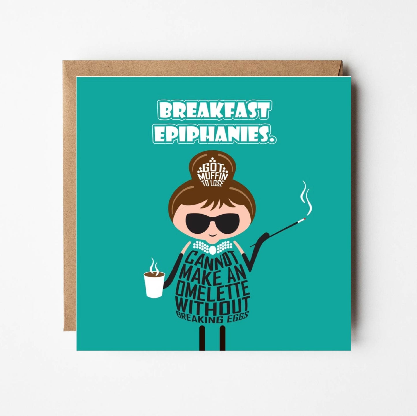 In a twist on Breakfast at Tiffany's, the card is titled Breakfast Epiphanies in white text on teal background. A cartoon Audrey Hepburn wears the iconic black dress and long gloves from the opening scene of Breakfast at Tiffany's. The jewellery in her hair is made of text which says Got Muffin to Lose. Her black dress is made of text which says You cannot make an omelette without breaking eggs”