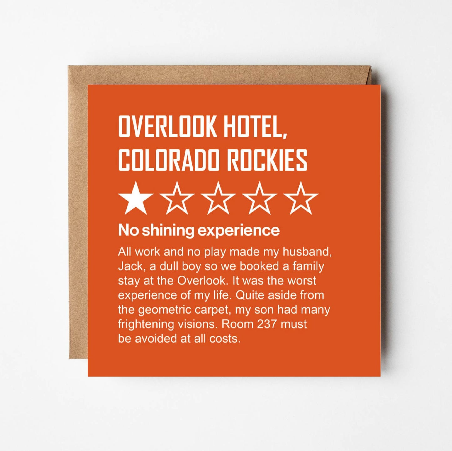 In style of online review, guest describes their stay at the Outlook Hotel, Colorado Rockies. White text on orange background. The guest awards 1 out of 5 stars stating: "All work and no play made my husband, Jack, a dull boy so we booked a family stay at the Outlook. It was the worst experience of my life. Quite aside from the geometric carpet, my son had many frightening visions. Room 237 must be avoided at all costs"