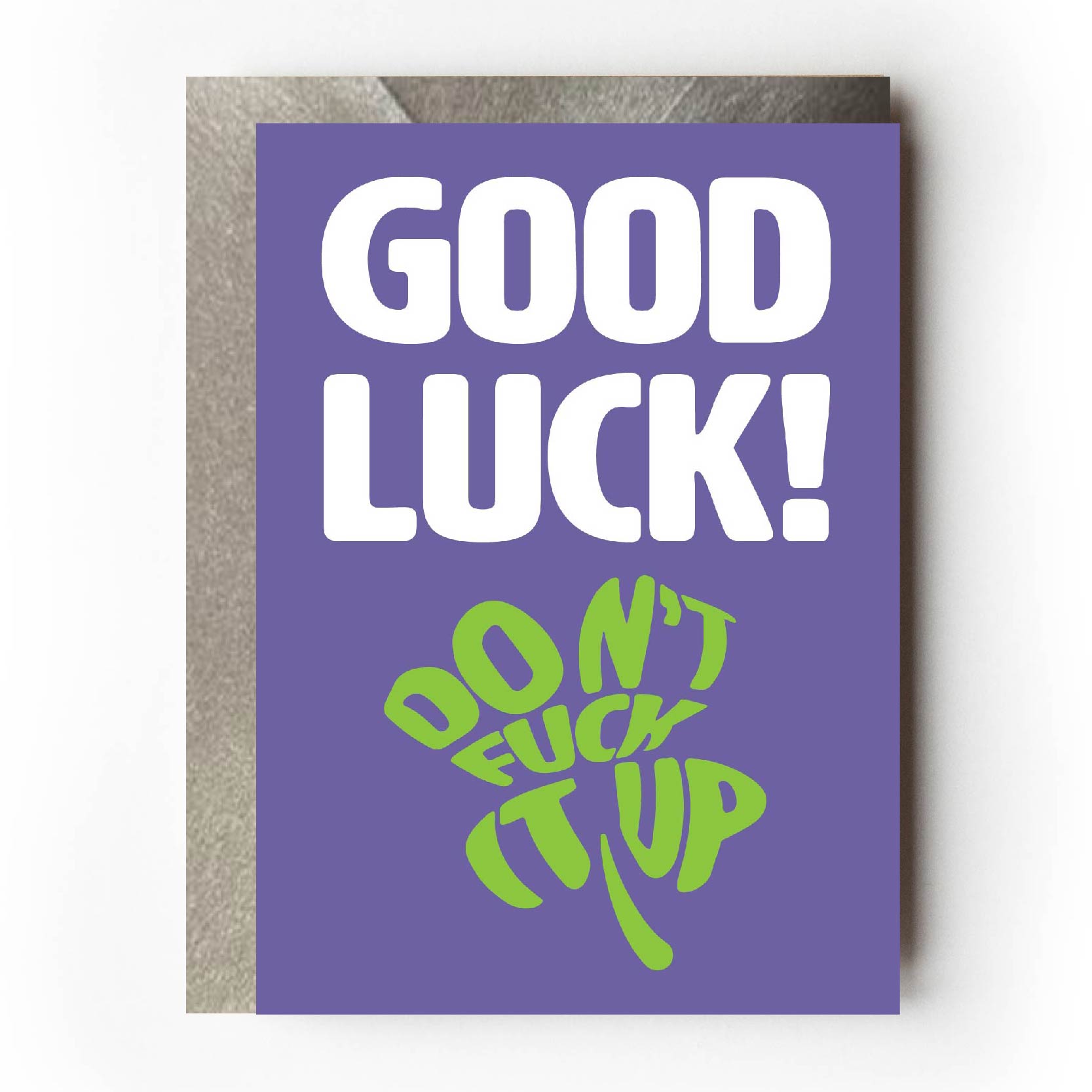Text on card is white and green against a purple background and states "Good luck!"  In the shape of a four-leaf clover, further text also states "Don't fuck it up"  Card measures 105 x 150mm and is supplied with a very striking pewter-effect eco-Kraft envelope.