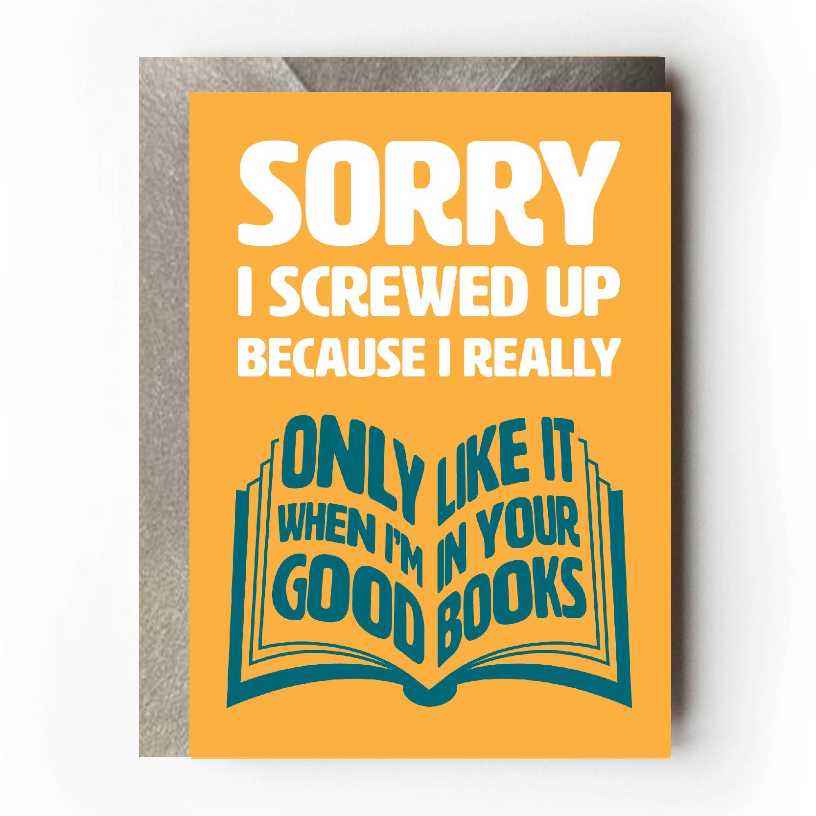 Text on card is white and teal against a yellow background and states "Sorry I screwed up"  In the shape of an open book, further teal-coloured text also states "Because I really only like it when I'm in your good books"  Card measures 105 x 150mm and is supplied with a very striking pewter-effect eco-Kraft envelope.