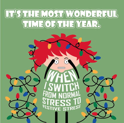 Card titled It’s the Most Wonderful Time of Year in white text on green background.  A lady with Christmas lights tangled in her wild red hair quips that it is When I switch from normal stress to festive stress. Card is 150mm square with eco-Kraft envelope.     