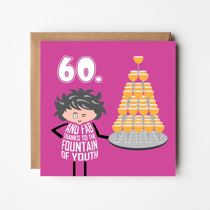 Text on card says: “60 – and fab thanks to the fountain of youth” in white text on pink background.  A cartoon lady holds a tray piled high with a fountain of wine glasses.  Car––d is 150mm square and supplied with eco-Kraft envelope.