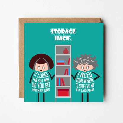 Card titled Storage Hack.  Two cartoon ladies stand either side of a shelving unit.  One lady says It looks fab but why did you get another one?  Her friends replies: I need somewhere to shelve my best laid plans.  The card is 150mm square and supplied with a brown, recycled Kraft envelope.  