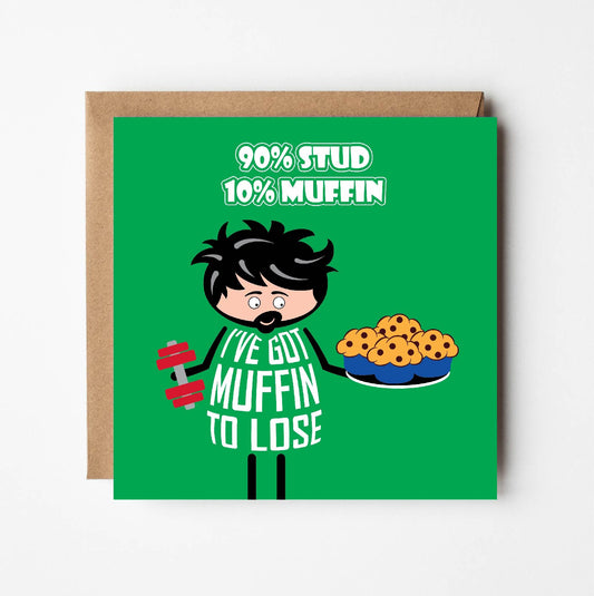 Card titled "90% Stud, 10% Muffin"   Cartoon guy holds dumbbell in one hand while eyeing up a plate of muffins in the other hand. His t-shirt says "I've got muffin to lose"
