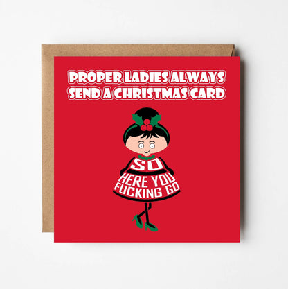 Card titled Proper ladies always send a Christmas card. A cartoon lady in a pretty dress and high heels then says So here you fucking go.  Card is 150mm square and supplied with eco-Kraft envelope.   
